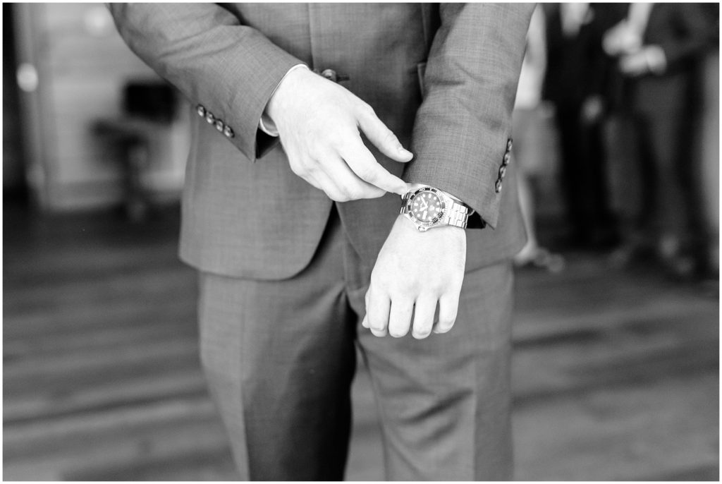 groom watch details on wedding day at barn of valhalla