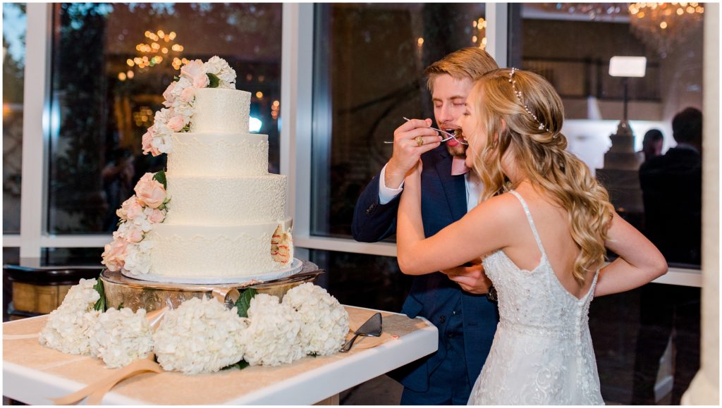 Ashton Gardens North Houston wedding cake at reception cutting cake