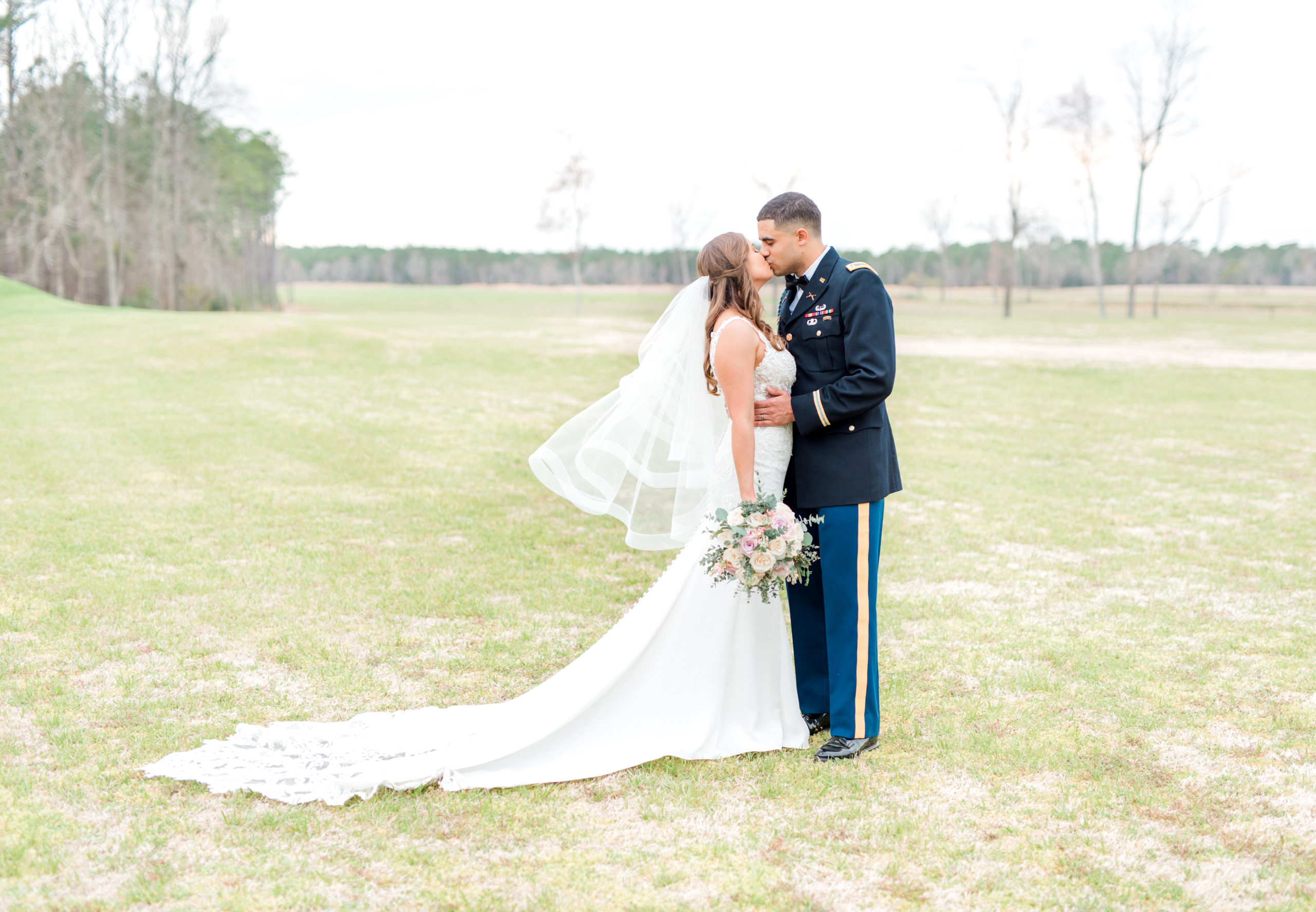 bride and groom kissing at spring wedding carolina barn